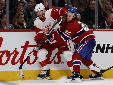 Jonathan Drouin drives Detroit Red Wings defenseman Nick Jensen into the boards at the Bell Centre on Monday, Oct. 15, 2018.