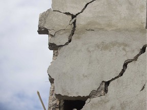 Cracks are seen in the facade of a home damaged by an earthquake in Haiti.