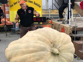 Harley Sproule of Ormstown celebrates after winning for largest pumpkin, at 1,761.5 pounds, in 2018.