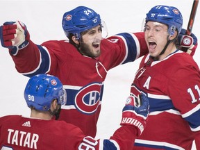 Canadiens' Tomas Tatar, Phillip Danault, centre, and Brendan Gallagher celebrate Gallagher's late goal Wednesday night against the Blues at the Bell Centre.