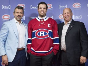 New Canadiens captain Shea Weber, centre, poses with general manager Marc Bergevin, left, and head coach Claude Julien following news conference at the Bell Sports Complex in Brossard on Oct. 1, 2018.