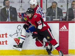 Senators defenceman Maxime Lajoie collides with Canadiens' Jesperi Kotkaniemi along the boards in Ottawa on Saturday, Oct. 20, 2018.