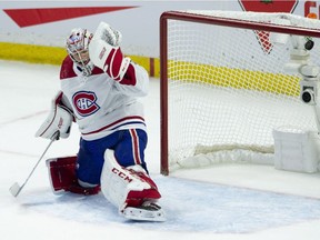 The puck deflects off the crossbar on a shot from Ottawa Senators' Mark Stone, not shown, past Montreal Canadiens goalie Carey Price during overtime NHL action in Ottawa on Saturday, Oct. 20, 2018.