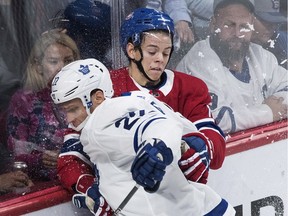 Montreal Canadiens' Jesperi Kotkaniemi checks Toronto Maple Leafs' Nikita Zaitsev in Montreal on Sept. 26, 2018.