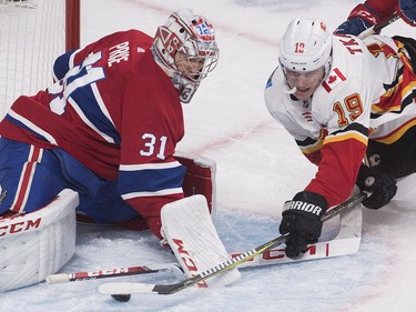 Carey Price makes a save as Calgary Flames' Matthew Tkachuk moves in during second period  in Montreal, Tuesday, Oct. 23, 2018.