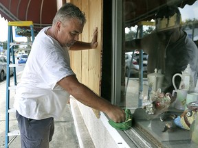Bobby Smith boards up the windows at Jani's Ceramics in Panama City, Fla., on Monday, Oct. 8, 2018, in preparation for the arrival of Hurricane Michael. (Patti Blake/News Herald via AP)