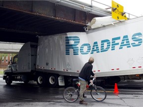 After a number of trucks got stuck in the Guy St. underpass, like this one in 2004, the city investigated and implemented a sensor warning system in 2012 that seemed to have the problem in hand.