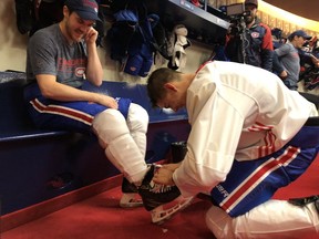 Canadiens rookie Jesperi Kotkaniemi unties teammate Andrew Shaw's skate laces at the Bell Sports Complex in Brossard on Friday, Oct. 19, 2018. Credit: Club de hockey Canadiens