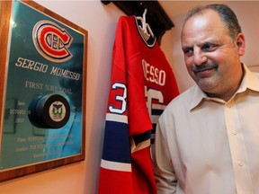 Former Montreal Canadien Sergio Momesso at his home in Kirkland on Nov. 16, 2011, with the mounted puck he used to score his first NHL goal on Oct. 19, 1985.  Momesso currently works as an analyst on Canadiens radio broadcasts.