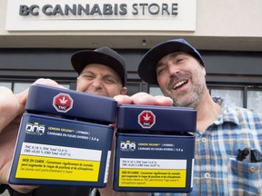 Don and Aaron (last names withheld) from the United States show off their cannabis purchases outside British Columbia's first legal cannabis store in Kamloops, B.C. Wednesday, Oct. 17, 2018.