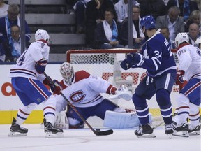 Canadiens goalie Carey Price searches for the puck as Leafs centre Austin Matthews lurks near the crease Wednesday night in Toronto.