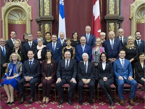 Quebec Premier François Legault poses with his cabinet during a ceremony at the National Assembly on Thusdat. From the left, first row, Minister of Seniors Marguerite Blais, Minister of Finances Éric Girard, Deputy Premier Geneviève Guilbault, Premier François Legault, Lt.-Gov. J. Michel Doyon, Minister of Justice Sonia LeBel, Minister of Immigration and House Leader Simon Jolin-Barrette, second row, Minister of Labour and Employment Jean Boulet, Minister of Tourism Caroline Proulx, Minister of Digital Transformation Éric Caire, Junior Transport Minister Chantal Rouleau, Minister of Transport François Bonnardel, Minister of Culture and Communications Nathalie Roy, Treasury Board president Christian Dubé, Minister of Environment MarieChantal Chassé, Minister of Economy and Innovation Pierre Fitzgibbon, Minister of Municipal Affairs and Housing Andrée Laforest, third row, Minister of Education Jean-François Roberge, Junior Economic Development Minister Marie-Eve Proulx, Junior Health Minister Lionel Carmant, Minister of International Relations and Francophonie Nadine Girault, Minister of Energy and Natural Resources Jonatan Julien, Junior Education Minister Isabelle Charest, Minister of Agriculture and Fisheries André Lamontagne, Minister of Native Affairs Sylvie D'Amours, Minister of Forest Wildlife and Parks Pierre Dufour, Minister of Families Mathieu Lacombe.
