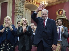 Quebec Liberal Opposition Leader Pierre Arcand waves to the applauding crowd before being sworn in as member of the National Assembly Monday, October 15, 2018 at the legislature in Quebec City. MNAs, from the left, Paule Robitaille, Lise Theriault and Christine Saint-Pierre applaud.