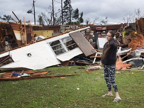 Haley Nelson stands in front of what is left of one of her father's trailer homes after Hurricane Michael ripped through the area on Oct. 10, 2018 in Panama City, Fla. The hurricane hit the Florida Panhandle as a category 4 storm.
