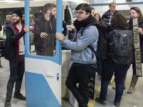 Peiple wait in line to buy an old métro car door during an STM garage sale in Montreal, Sunday, Oct. 14, 2018.