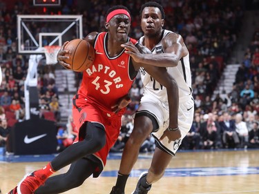 Toronto Raptors forward Pascal Siakam pulls away from Brooklyn Nets guard Treveon Graham during first-half NBA pre-season game in Montreal on Wednesday, Oct. 10, 2018.