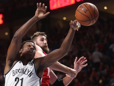 Brooklyn Nets guard Treveon Graham goes up with Toronto Raptors centre Jonas Valanciunas during second-half NBA pre-season game in Montreal on Wednesday, Oct. 10, 2018.