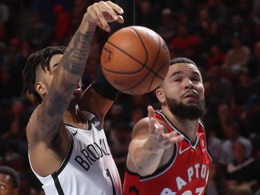 Toronto Raptors guard Fred VanVleet tries to put the ball up  against Brooklyn Nets guard D'Angelo Russell during first-half NBA pre-season game in Montreal on Wednesday, Oct. 10, 2018.