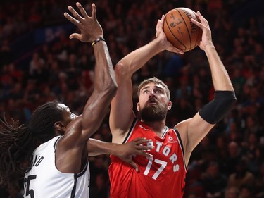 Toronto Raptors centre Jonas Valanciunas shoots ball to the net against Brooklyn Nets forward Kenneth Faried during first-half NBA pre-season game in Montreal on Wednesday, Oct. 10, 2018.