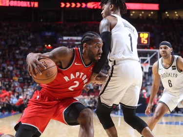 Toronto Raptors forward Kawhi Leonard drives to the basket against Brooklyn Nets guard D'Angelo Russell during first-half NBA pre-season game in Montreal on Wednesday, Oct. 10, 2018.