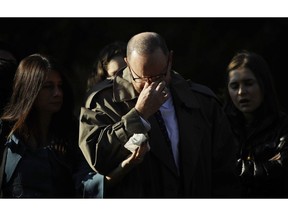 A mourner reacts outside Rodef Shalom Congregation before the funeral services for brothers Cecil and David Rosenthal, Tuesday, Oct. 30, 2018, in Pittsburgh. The brothers were killed in the mass shooting Saturday at the Tree of Life Synagogue.
