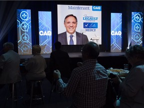 Coalition Avenir Quebec supporters watch the election results with their leader leader Francois Legault on the giant screen in Quebec City, on Monday, October 1, 2018.