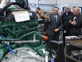 Premier-elect François Legault visited the Prevost Car assembly plant during campaign stop in September. The factory is struggling to find workers to fill positions that pay more than $26 an hour.