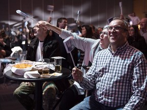 Coalition Avenir Quebec supporters react as a majority government is projected in Quebec City, on Monday, October 1, 2018.