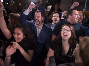 Coalition Avenir Québec supporters react as a majority government is projected on Monday.