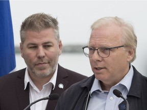 Former Parti Quebecois Leader Jean-Francois Lisee, right, speaks at a news conference Monday, September 3, 2018 in Matane Que. Current interim leader Pascal Berube, looks on.