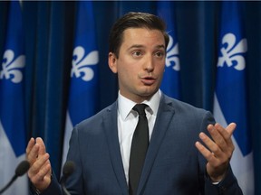 Coalition Avenir Quebec MNA Simon Jolin-Barrette responds to reporters questions on the government transition, Tuesday, October 9, 2018 at the legislature in Quebec City.