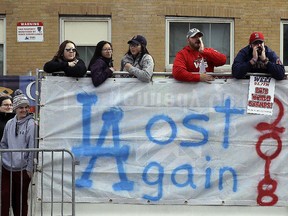 Boston Red Sox fans line the parade route, waiting to celebrate the team's World Series championship over the Los Angeles Dodgers, Wednesday, Oct. 31, 2018, in Boston. (AP Photo/Charles Krupa)