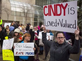 Protesters hold signs in support of Cindy Gladue outside Edmonton's city hall on April 2, 2015. The case of an Ontario trucker acquitted in the death of an Alberta woman referred to at trial as a "native" and a "prostitute" went before the Supreme Court this month in what could set a precedent in Canada's sexual assault laws. Bradley Barton says Cindy Gladue died after a night of consensual, rough sex in an Edmonton motel in June 2011. Her body was found in the bathtub after Barton called 911. She had an 11-centimetre cut in her vagina and had bled to death.