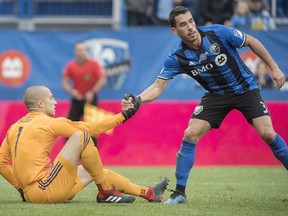 "We have to be our best version of ourselves (on Sunday against the Revolution)," says Montreal Impact's Daniel Lovitz, right, helping teammate Evan Bush up off of the turf during second half MLS action against Columbus Crew in Montreal on Oct. 6, 2018.