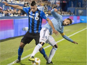 Montreal Impact's Saphir Taider, left, and New York City FC's David Villa battle for the ball during first half MLS soccer action in Montreal on September 22, 2018. Saphir Taider believes the Impact need to win their final three games of the season if they have any hope of making the playoffs. Montreal plays host to Columbus on Saturday night.