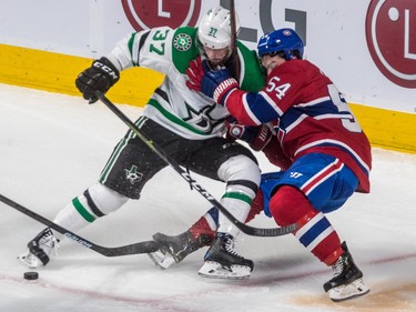 Left wing Charles Hudon and Dallas Stars centre Justin Dowling tangle while losing control of the puck in second period at the Bell Centre on Tuesday, Oct. 30, 2018.