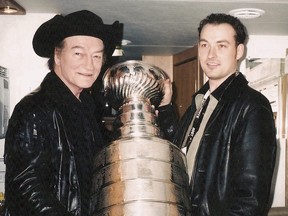 The late Stompin' Tom Connors and his son, Tom Jr. hoist the Stanley Cup in a pure Canadian moment.