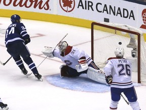 Leafs centre Auston Matthews scores the winning goal past Canadiens' Carey Price in overtime as defenceman Jeff Petry watches helplessly Wednesday night.
