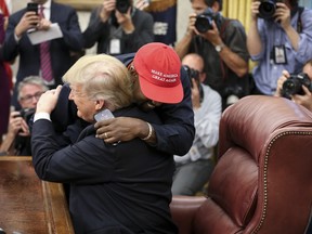 Rapper Kanye West hugs U.S. President Donald Trump during a meeting in the Oval office of the White House on Oct. 11, 2018 in Washington, DC. (Photo by Oliver Contreras - Pool/Getty Images)