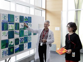 Art therapist Samantha Remondière, right, and Dr. Olivier Beauchet, left, discuss artworks by geriatric patients at the Jewish General Hospital last year.