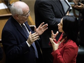 Beaconsfield Mayor Georges Bourelle speaks with Montreal Mayor Valérie Plante after an agglomeration council meeting in 2018.