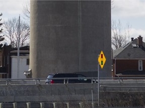A mini-van drives by the Ste-Anne-de-Bellevue water tower along Highway 20.