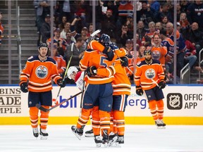 The Edmonton Oilers’ Kevin Gravel (No. 5) and Kris Russell (No. 4) celebrate Russell's goal against the Montreal Canadiens during the third period of NHL game at Edmonton’s Rogers Place on Nov. 13, 2018.