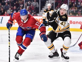 Brett Kulak of the Montreal Canadiens and Danton Heinen of the Boston Bruins chase after the puck during the NHL game at the Bell Centre on Nov. 24, 2018, in Montreal.