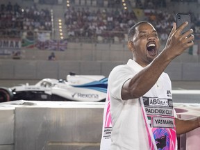 Actor Will Smith takes a selfie trackside as Lance Stroll of Canada driving the (18) Williams Martini Racing FW41 Mercedes passes him during the Abu Dhabi Formula One Grand Prix at Yas Marina Circuit on November 25, 2018 in Abu Dhabi, United Arab Emirates.
