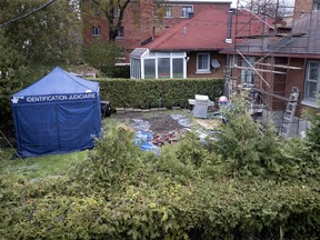 Police investigators cover a freshly dug section of the backyard during the search for Josiane Argin in Montreal Nov. 1, 2018.