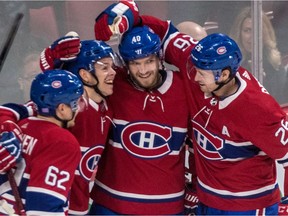 Canadiens rookie Jesperi Kotkaniemi (second from left) is congratulated by teammates Artturi Lehkonen (62), Joel Armia (40) and Jeff Petry (26) after scoring his first NHL goal against Washington Capitals goaltender Braden Holtby during first period of NHL game at the Bell Centre in Montreal on Nov. 1, 2018.