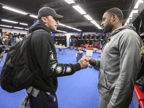 Alouettes quarterback Johnny Manziel, left, says goodbye to receiver Eugene Lewis after cleaning out his locker at the Olympic Stadium in Montreal on Sunday, Nov. 4, 2018.