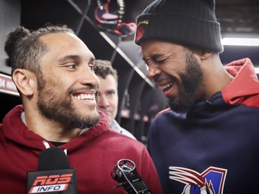 Jermaine Robinson, right, pretends to cry on Alouettes team-mate Chip Cox's shoulder as players cleaned out their lockers at the Olympic Stadium in Montreal on Sunday, Nov. 4, 2018.