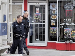 Police investigators leave Cafe Cubano, the scene of an overnight shooting in Montreal Nov. 7, 2018.